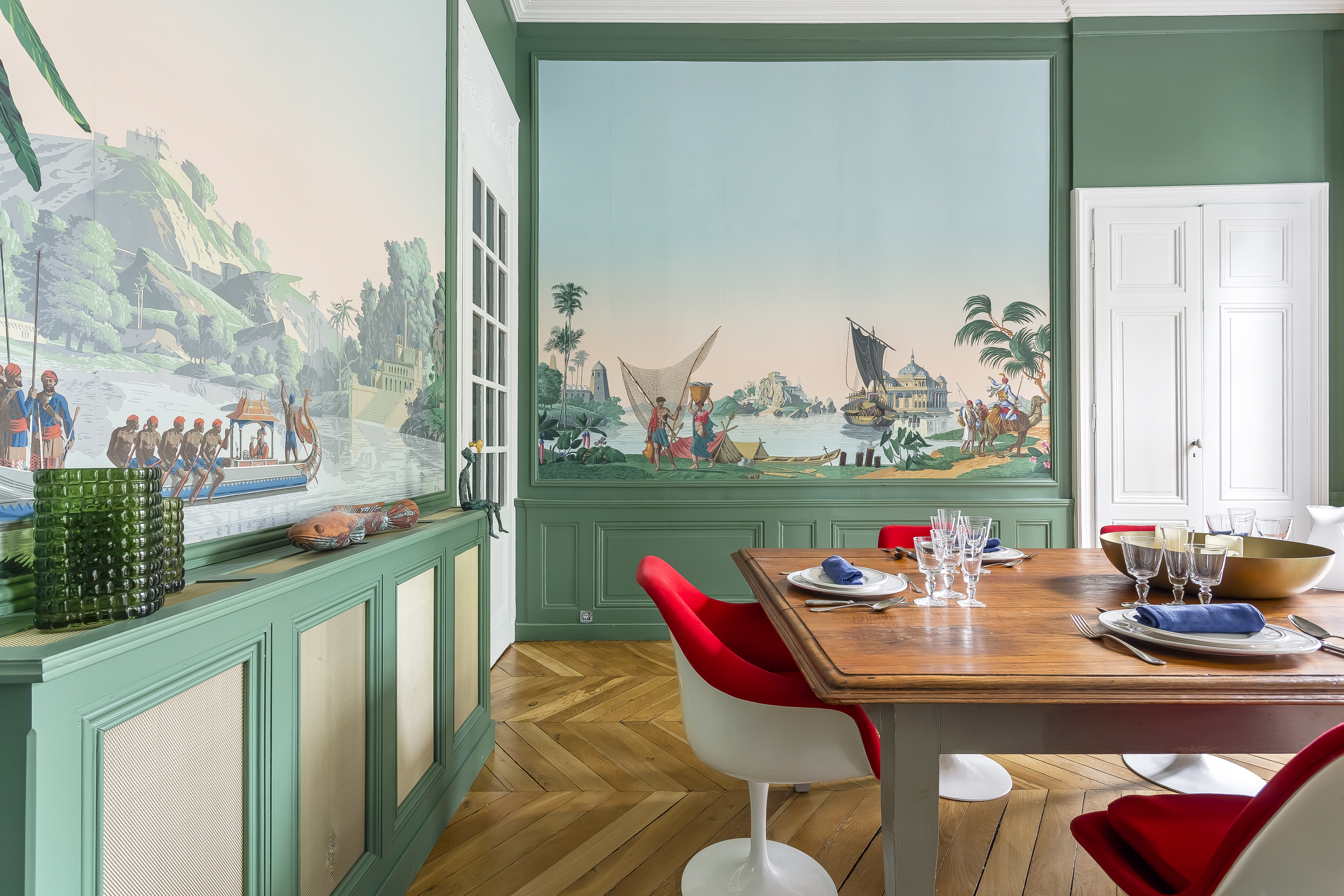 Tilsitt dining room with green walls and panoramic murals.