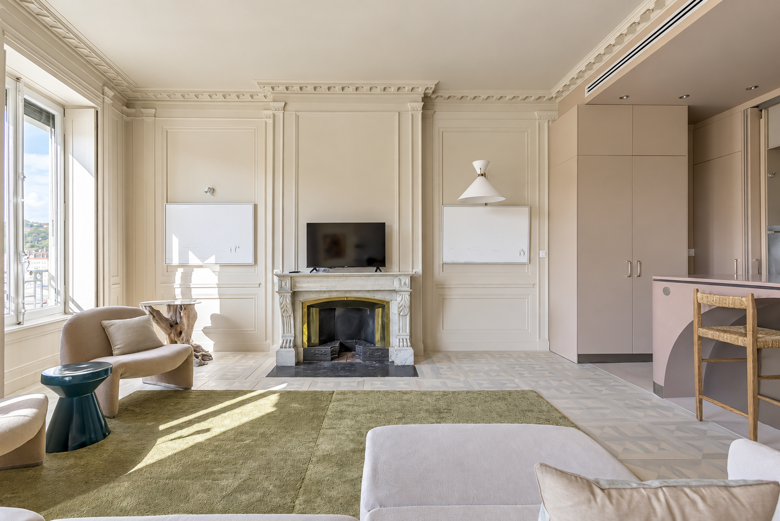 Living room of the Saône apartment in Lyon, with a fireplace and windows on Quai de la Pêcherie