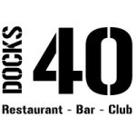 Logo noir et blanc avec le mot DOCKS à la verticale, à côté d'un grand 40. En dessous, le texte Restaurant - Bar - Club met en avant un lieu vivant, idéal pour ceux qui recherchent une location meublée à Lyon ou des séjours de moyenne durée. | 2BeApart Lyon